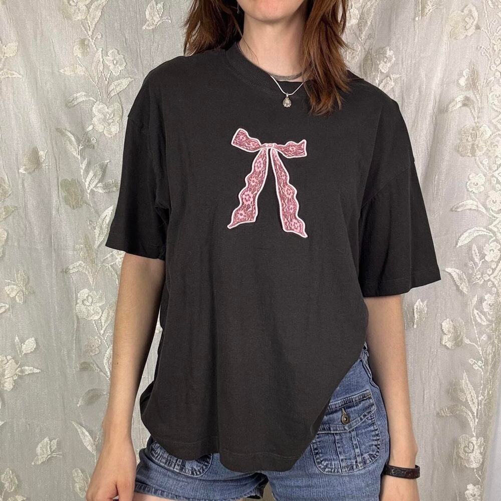 Dark grey graphic tee with pink lace bow design